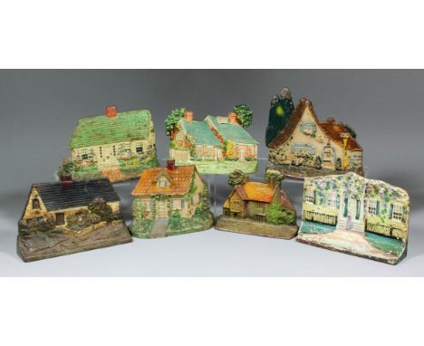 A collection of early 20th Century cast iron door stops modelled and painted as cottages, including - "Hubley 444 Cape Cod Co