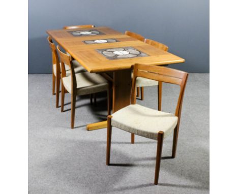 A 1970's Danish teak rectangular extending dining table with one extra leaf, the cleated top inset with ceramic tile panels o