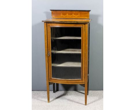 An Edwardian mahogany bow-front dwarf display cabinet with upstand, the whole inlaid with stringings and satinwood bandings, 