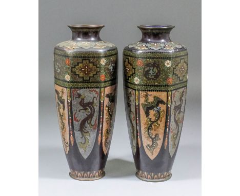 A pair of late 19th/early 20th Century Chinese enamel hexagonal vases, the panels with fabled creatures below formal designs,
