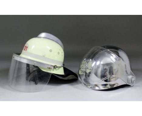 A 1970's East German fireman's steel helmet finished in cream and with aluminium cresting, with perspex protective mask and l