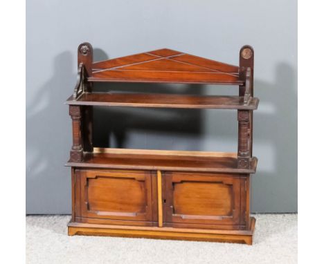 A Victorian mahogany wall mounted cabinet, fitted open shelf on turned supports, cupboard under closed by a pair of panelled 