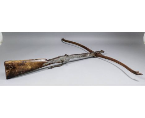 A 19th Century Continental sporting crossbow, with 34ins bow and steel mounted walnut stock and curved trigger, 30ins overall