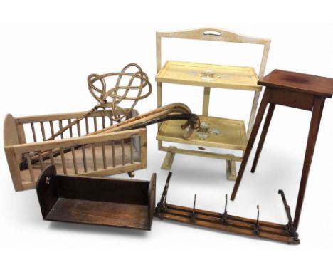 An oak bookrack, c.1920;&nbsp; &nbsp;a door hanging coat hook rail;&nbsp; &nbsp;a pine doll's cot;&nbsp; &nbsp;walking sticks