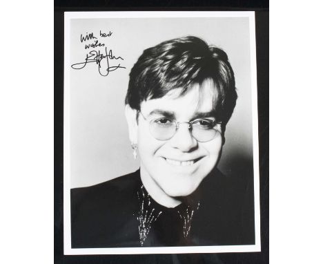 Elton John, a 25 x 20cm black and white portrait photograph, signed top left "Best Wishes Elton John", together with a 1989-1