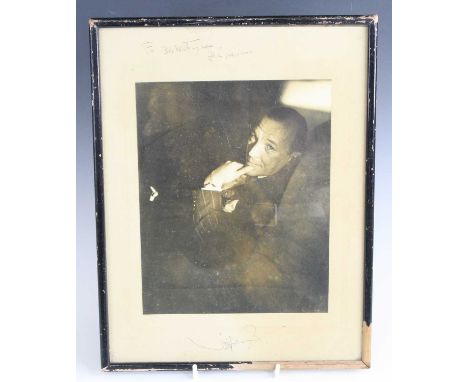 A signed black and white photographic print of Noel Coward, handwritten "For Bob Whtingham? all good wishes", 34 x 26.5cm, to