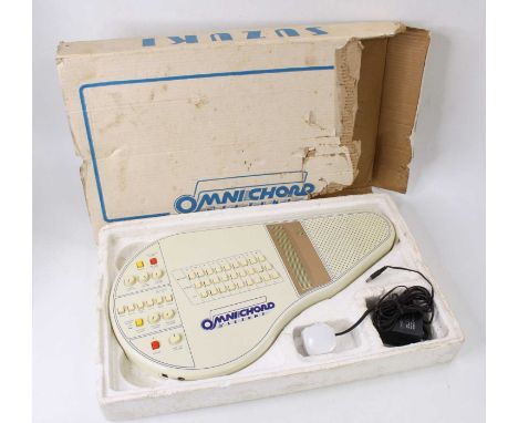 A Suzuki OM-27 Omnichord, in off-white plastic, serial No. 073797, with instruction manual, in remains of original box and pa