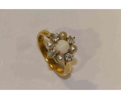 An opal, diamond and seed pearl ring, the round cabochon cut opal four claw set within a surround of four seed pearls alterna