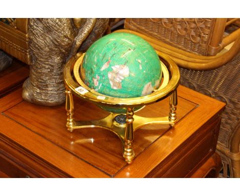 Semi-precious stone celestial globe on green ground