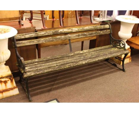 Weathered cast and wood slat garden bench