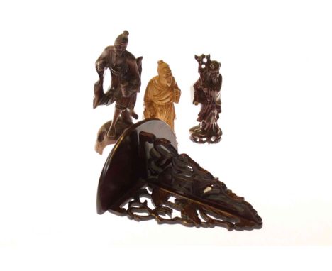 Three Oriental carved figures and a wall bracket (4)