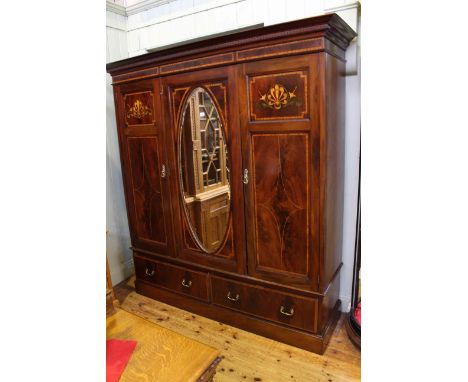 Edwardian inlaid mahogany triple wardrobe having central mirror door flanked by two inlaid doors above two long drawers