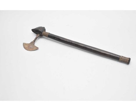 A Southern African tribal Shona axe, the shaped metal head mounted in a mask finial, on a slightly tapering shaft with wire-w