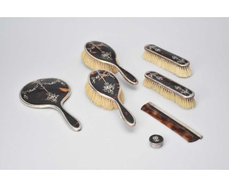 A silver and tortoiseshell mounted dressing table set, E S Barnsley &amp; Co, Birmingham 1921, comprising; a hand mirror, two