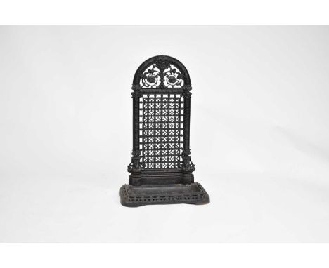 A Coalbrookdale type cast iron umbrella/stick stand, the arched back with openwork scrolling foliage and flower cresting abov