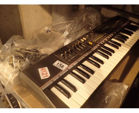 Casio MT68 organ and power adapter with manual