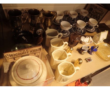 Shelf of assorted items including tankards and glass