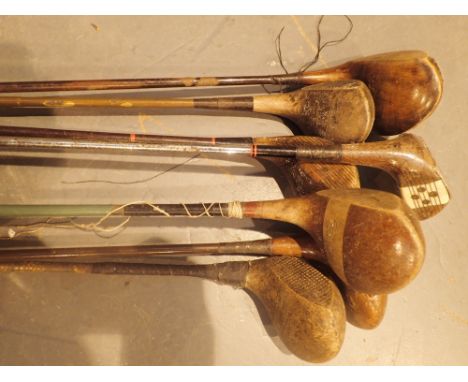 Seven vintage golf clubs with wooden heads