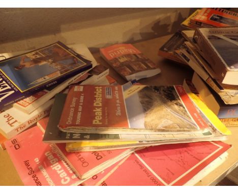 Shelf of assorted maps and books including Ordnance Survey 