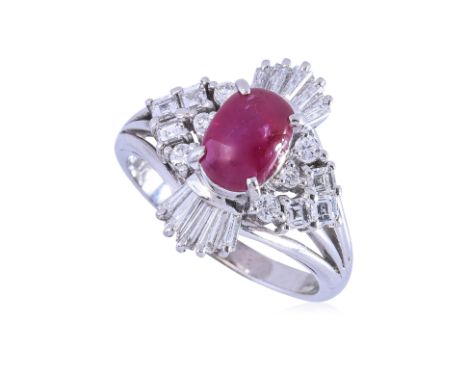 A STAR RUBY AND DIAMOND RING Featuring a star ruby showing a six ray asterism, weighing approximately 1.70 Cts (marked), moun