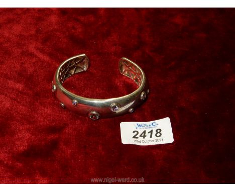 A 925 silver heavy Bangle with multi stone setting.