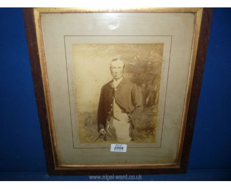 A wooden framed three quarter portrait of a gentleman in hunting dress. 13 3/4" x 16".