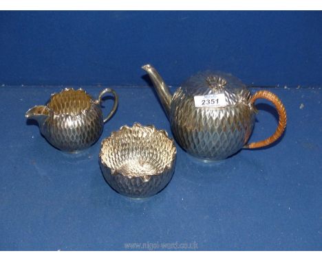 A three piece Birmingham silver 1890 Teaset by Norton and White with hammered bodies and crimped edges, the teapot with whick