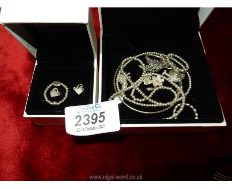A memorial adjustable Bracelet with angel wing, paw print, heart and 'T' charm, a Chlobo elastic mini ring and a pair of Reve