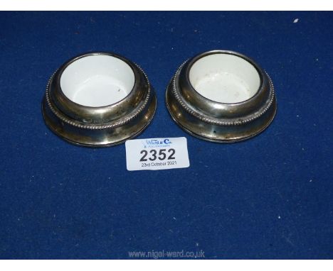 A pair of silver Salts, Birmingham 1905, with ceramic liners.