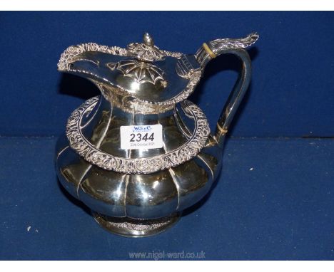 A Silver Hot water Jug with lobed design, embossed foliage with an acorn finial, Newcastle 1826, 833 grams