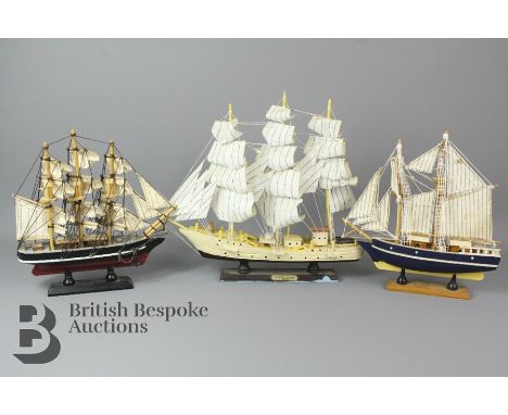 Three small model ships, two being models of the Cutty Sark and one other. Largest ship is 32cms in length and 28cm tall, the