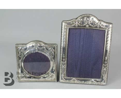 Two silver photo frames, the first approx 13 x 15cms, the other an ornate example approx 24 x 17cms, both with velvet backs.