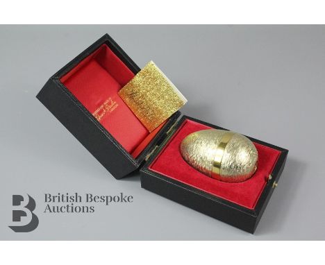 Stuart Devlin Surprise Novelty Egg, boxed with stand, the egg opens to reveal a cat and mouse playing with a ball of wool, Lo
