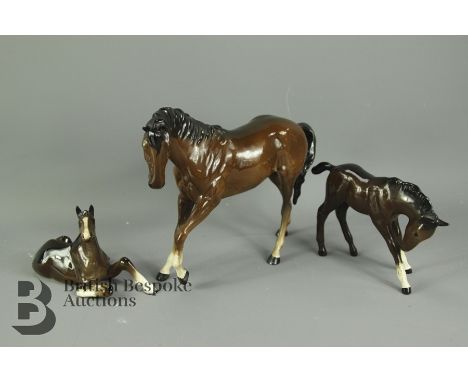 Beswick figurines, including a mare with white socks and two foal, the first depicted seated and the second standing. (3)