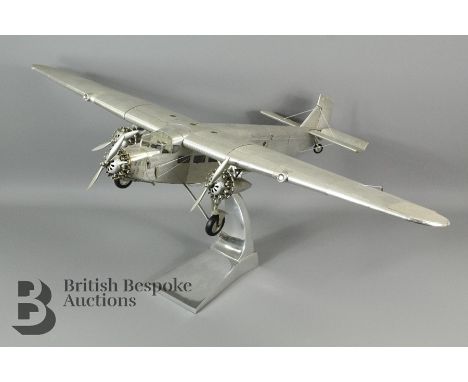 A Ford Trimotor AP452 model by Authentic Models on a metal stand. The aircraft is made from aluminium metal sheet on a lightw