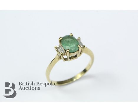 18ct yellow gold emerald and diamond ring, the ring set with an oval-cut emerald, approx 8 x 6mm and two baguette diamonds me