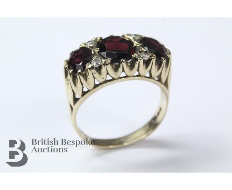 9ct yellow gold garnet ring, the ring stamped 375 London hallmark dated 1977, the central garnet approx 9 x 7mm, flanked by t