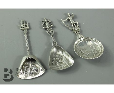 Three Continental silver caddy spoons, two with tavern scenes and the third depicting a stag hunt, gross weight 79.7 gms.