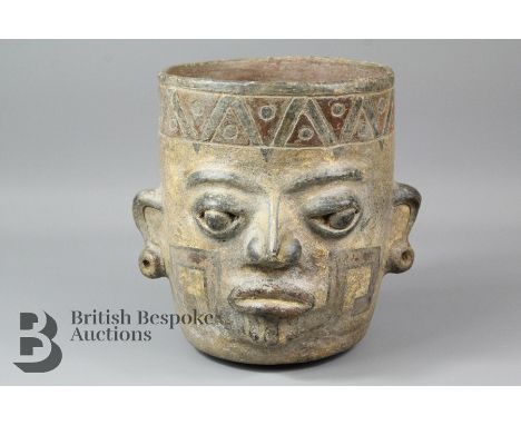 South American ceramic mixing bowl, the body of the bowl featuring a mask painted in polychrome, approx 18.5 x 18 cms.