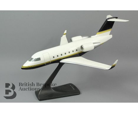 A Bombardier Challenger 604 model aircraft on a stand made by Space Models, London, 41cm in length with a 39cm wingspan.