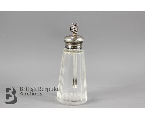 A silver and cut glass chilli oil bottle, with a devil finial to the scoop.