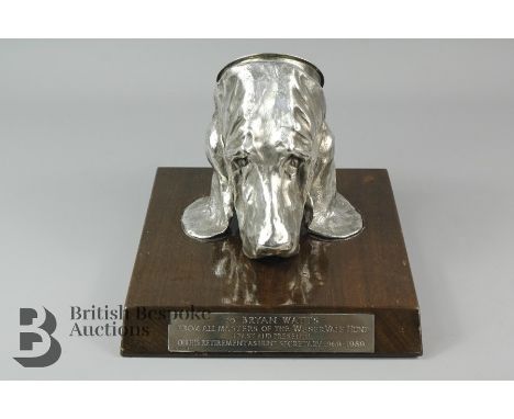 Mark Coreth b.1958 white metal stirrup cup, modelled as a bloodhound, signed M.Coreth approx 15 cms h, raised on a fitted oak