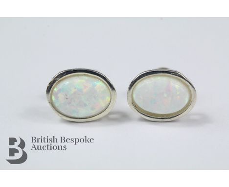 Pair of silver and opal stud earrings, each opal approx 8 x 6 mm.&nbsp;