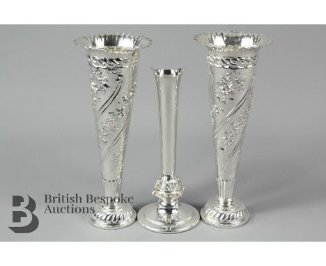 A pair of decorative silver vases, London 1956 mm W.C 16cm height, together with a small silver specimen vase, Birmingham 194