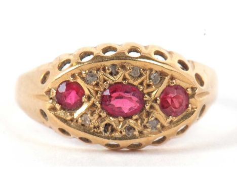 An 18ct ruby and diamond ring, the oval and round rubies set within a marquise shaped plaque set with diamond highlights, wit