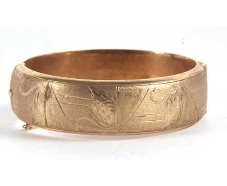 A 9ct hinged bangle, the upper half with textured and engraved swans, the lower half plain, hallmarked Birmingham 1966, with 