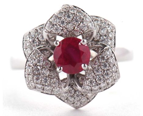 An 18ct ruby and diamond rose ring, the central round ruby surrounded by diamond pave set petals, total weight of diamonds es