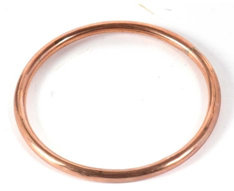 A 9ct rose gold hollow bangle, hallmarked Birmingham 1923, inner diameter 7.4cm, 7.2g