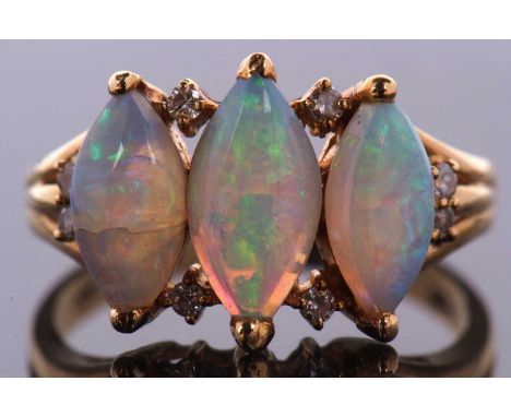 An 18ct three stone opal ring, the three marquise opal cabochons, set with diamond highlights above, below and to shoulders, 