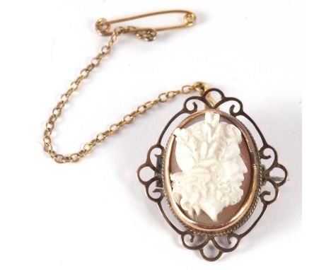 A cameo brooch, the oval shell cameo carved in high relief with a portrait bust of a classical gentleman, in rubover mount wi